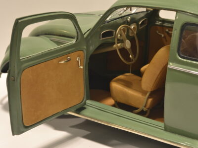 Interior view of a model Volkswagen Beetle in green with brown seats
