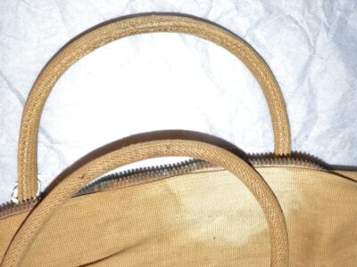 A close up of the bag's two handles, with the zip also clearly shown